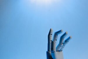 AI Strategy Consulting for Measurable Business Outcomes Robot fingers on blue background