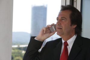 Man in business suit holding a phone