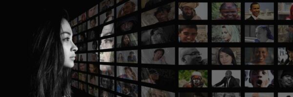 Woman looking at television screens