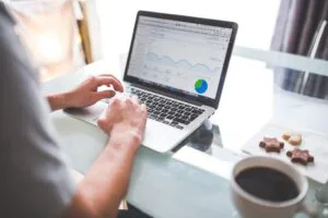 Business Change Office (BCO) Adoption, Enablement & Change Analytics Image of person working on a laptop