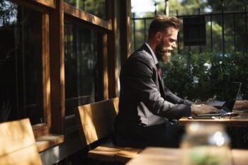 Man in business suit working on a laptop
