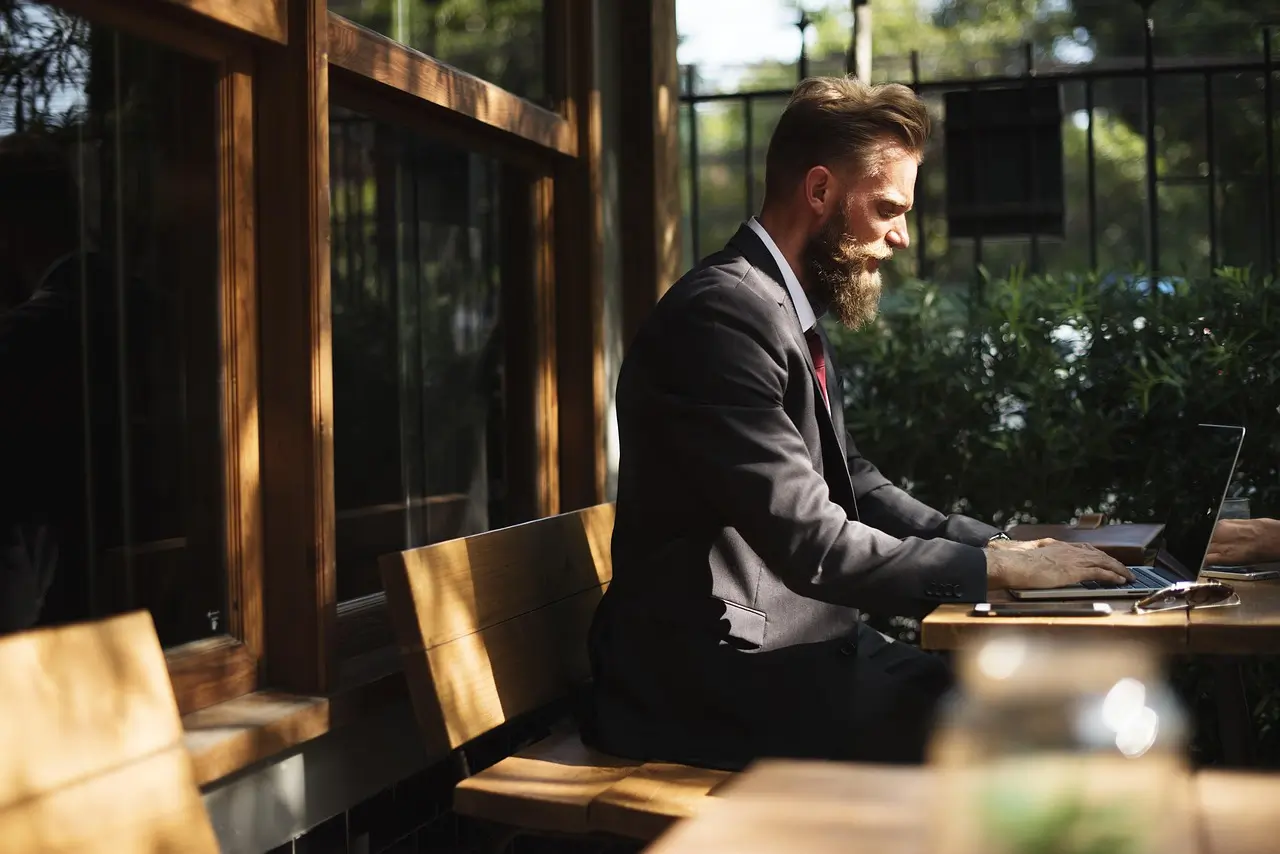 Man in business suit working on a laptop
