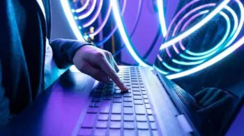 Image of man pressing button on keyboard