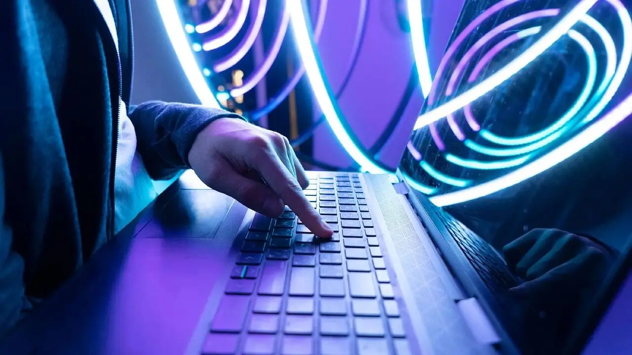 Image of man pressing button on keyboard