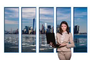 Image of a woman in business suit holding laptop