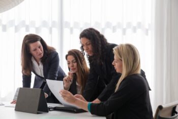 Women in blazers having a meeting in an office