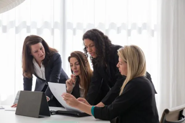 Women in blazers having a meeting in an office