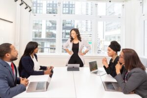 Image of several people in business attire having a meeting