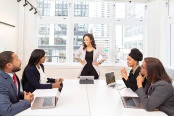 Image of several people in business attire having a meeting