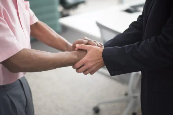 Close-up shot of two people shaking hands