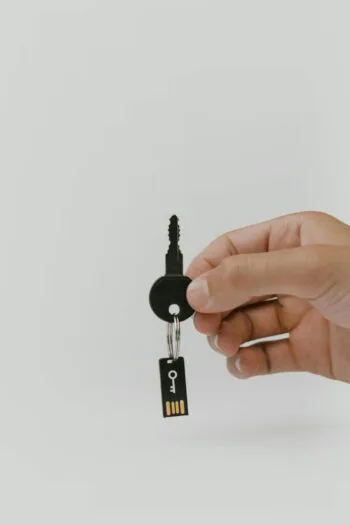 Hand holding a key with a USB drive