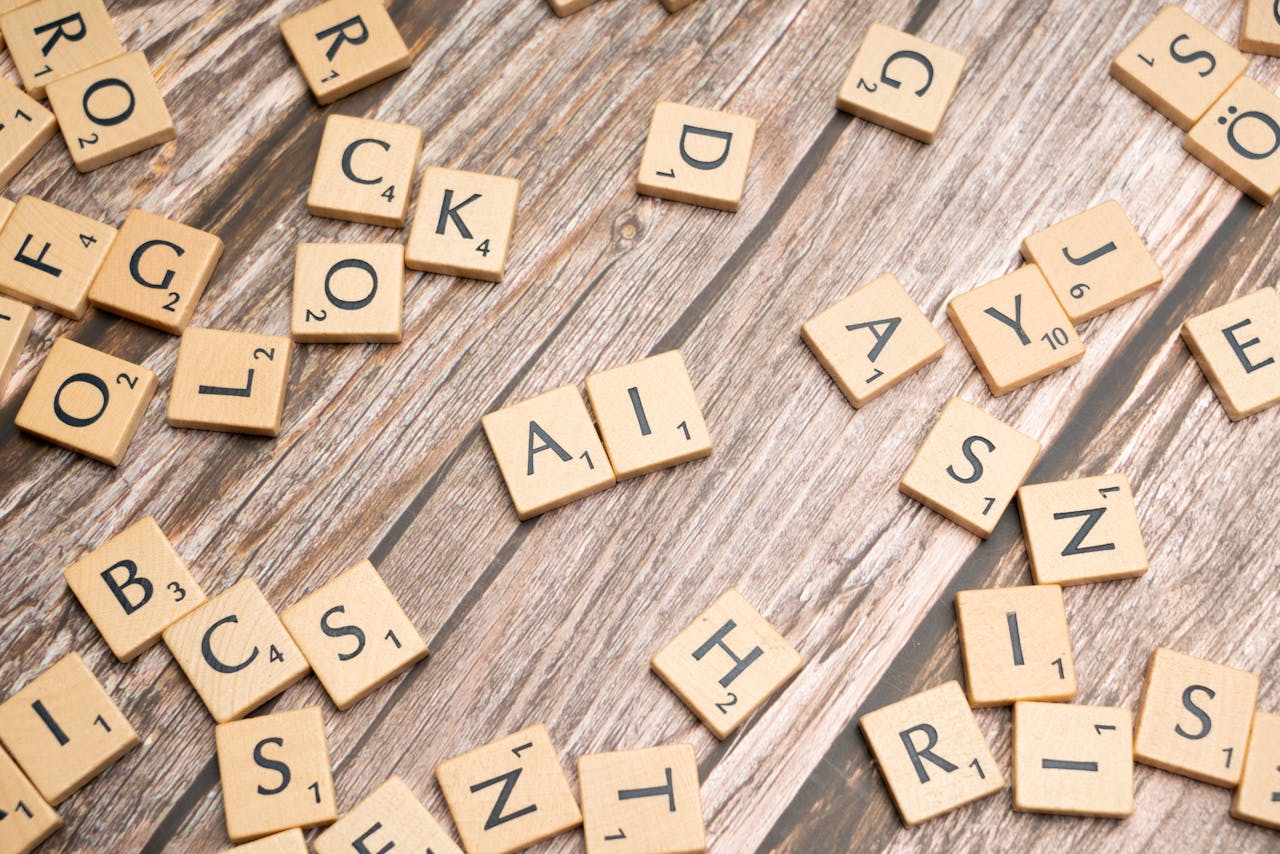 Scrabble tiles on a wooden board spelling AI