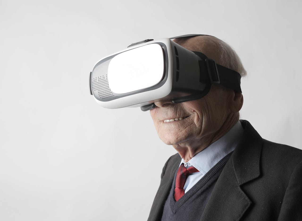 Senior man using virtual reality goggles