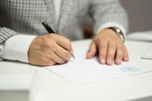 Man writing on a white paper