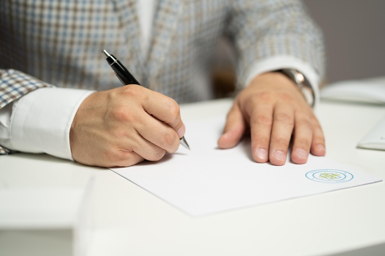 Man writing on a white paper