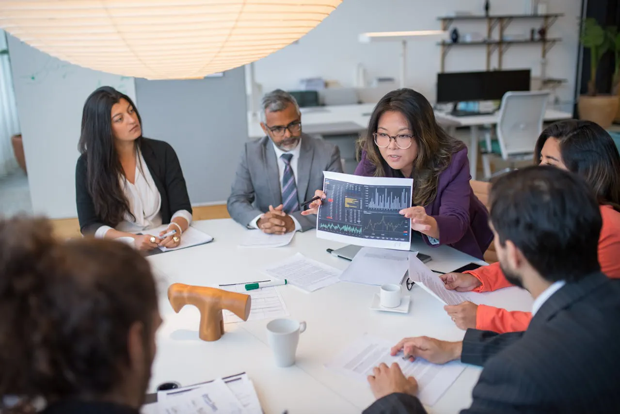 Woman in blue blazer presenting in a meeting