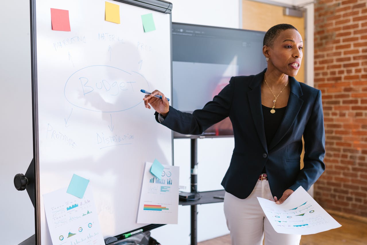 Person pointing at a white board