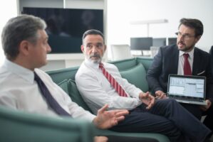 Men sitting on sofa having a conversation