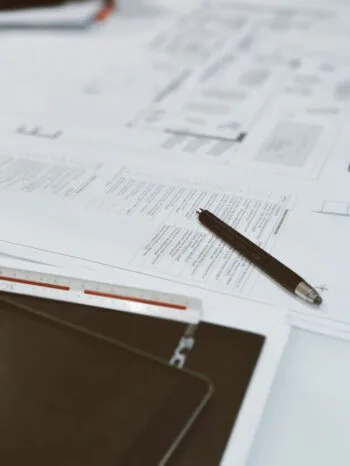 Pen and paper which has writing on it